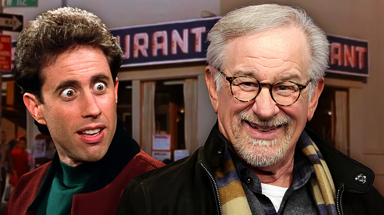 A google eyed Jerry Seinfeld and a grinning Steven Spielberg stand in front of Monk's Cafe