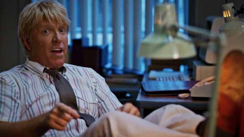 Jake Busey at desk 