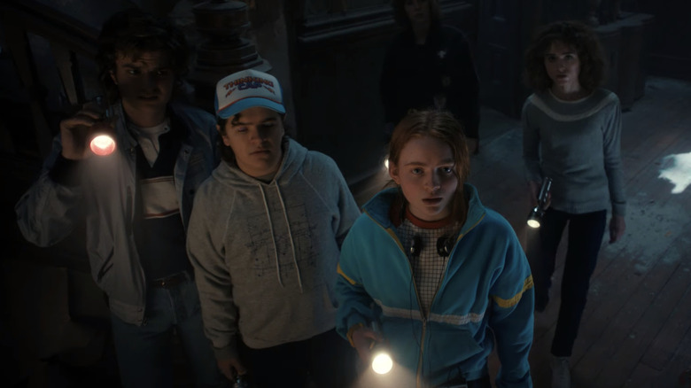 The gang in Stranger Things 4 with flashlights