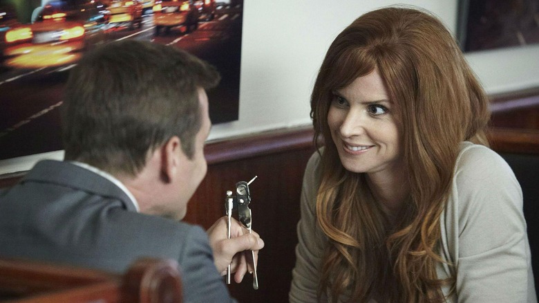 Gabriel Macht's Harvey and Sarah Rafferty's Donna looking at the can opener in a diner booth in Suits