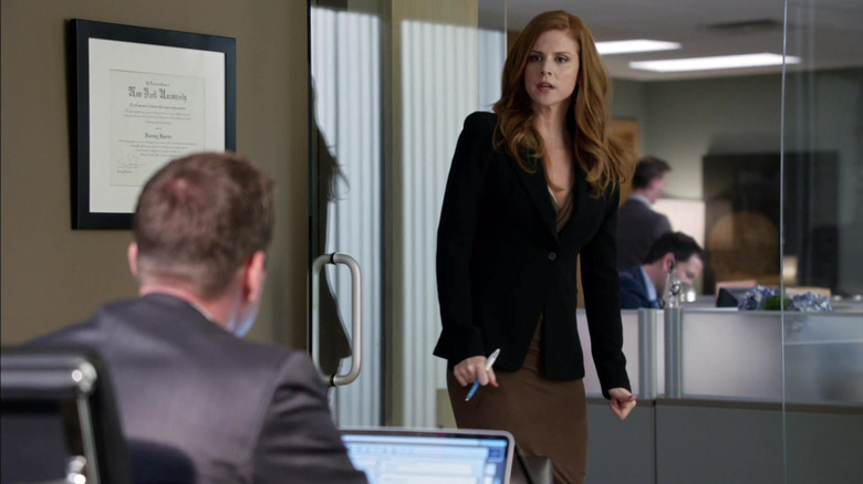 Sarah Rafferty's Donna standing in the office of Gabriel Macht's Harvey in the Suits episode High Noon