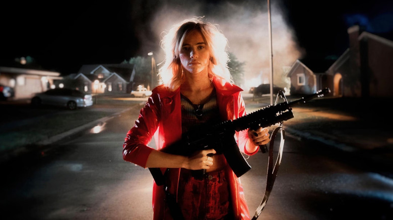 Assassination Nation Suki Waterhouse holds a gun in a neighborhood