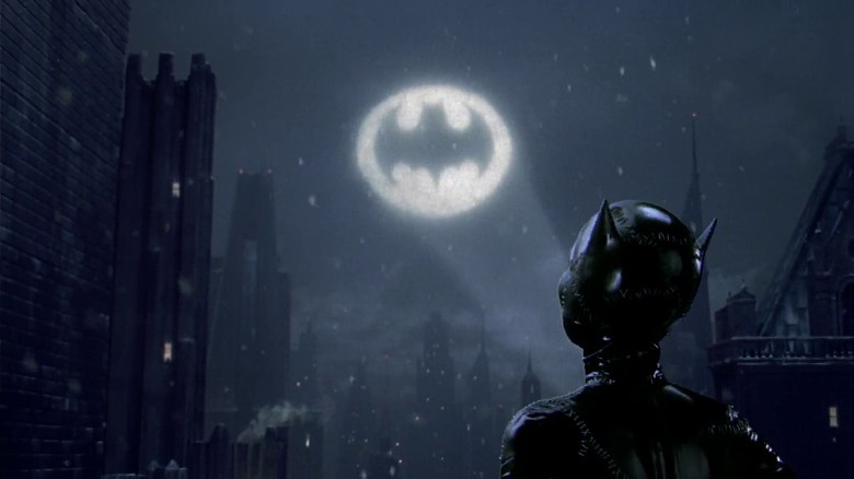 Catwoman looking up at bat-signal in Batman Returns