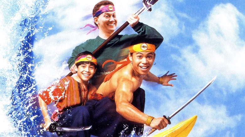 Nicholas Cowan, Rob Schneider, and Ernie Reyes Jr surfing with weapons 