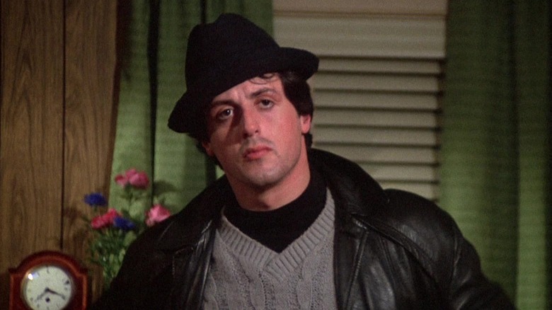 Sylvester Stallone's Rocky Balboa stands in his living room with his hands on his hips in Rocky