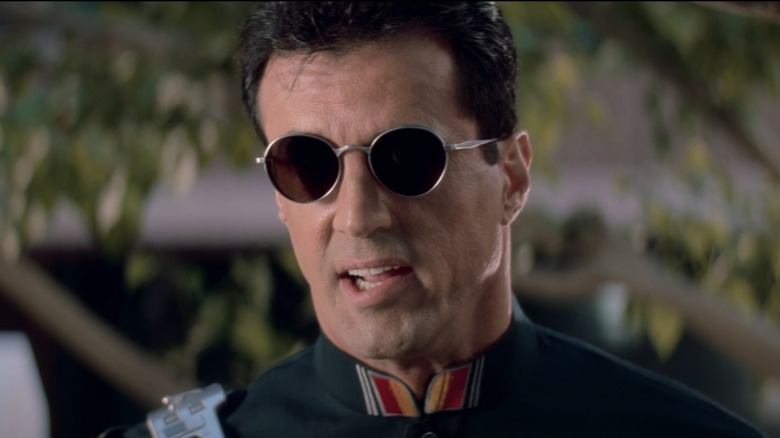 Sylvester Stallone's John Spartan stands in uniform in Demolition Man