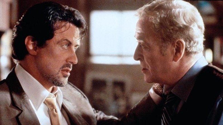 Sylvester Stallone as Jack Carter faces down Michael Caine as Cliff Brumby in Get Carter