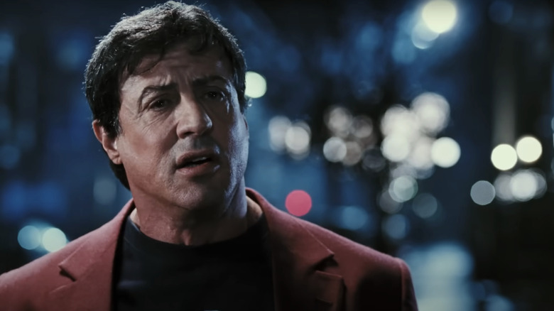 Sylvester Stallone's Rocky Balboa stands in the street talking in Rocky Balboa