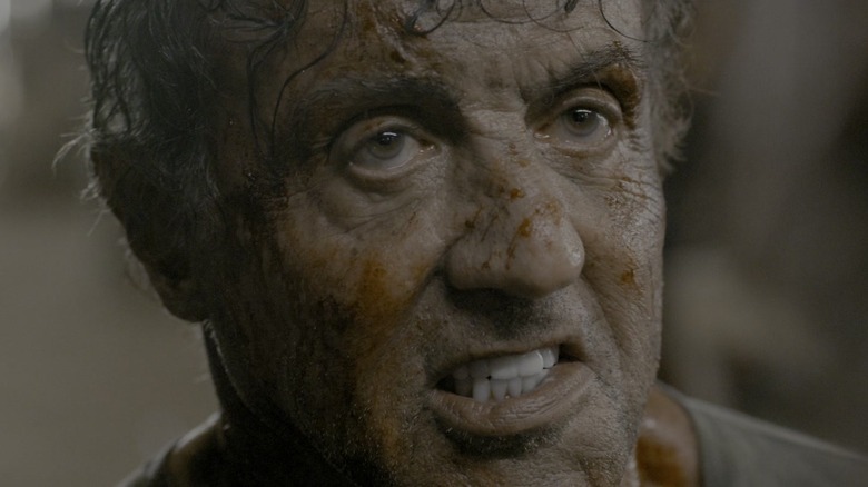 Sylvester Stallone's John Rambo grits his teeth while covered in blood in Rambo: Last Blood