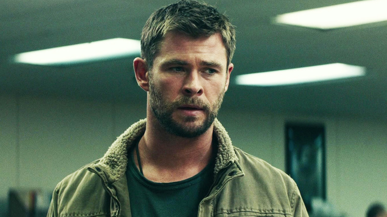 Chris Hemsworth's Mitch Nelson stands in an office in 12 Strong