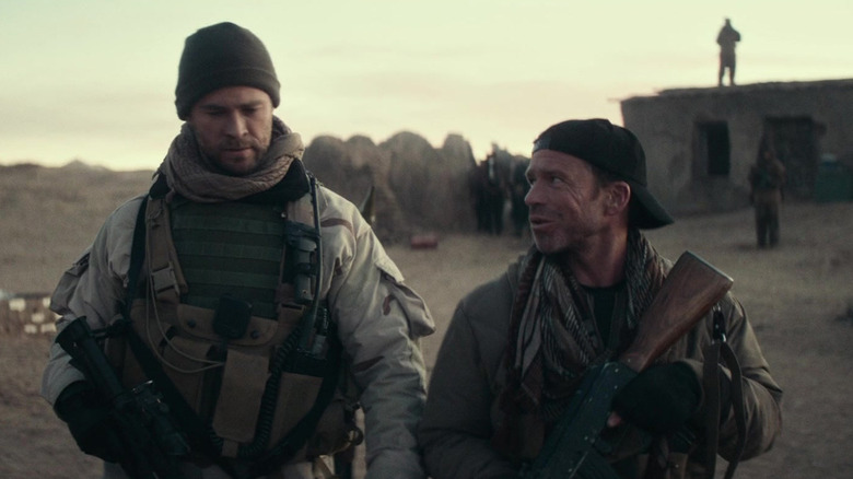 Chris Hemsworth's Mitch Nelson stands alongside Taylor Sheridan's Field Officer Brian in 12 Strong