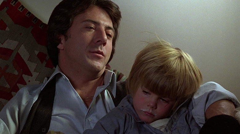 Ted Kramer sitting with his arm around his son in Kramer vs. Kramer