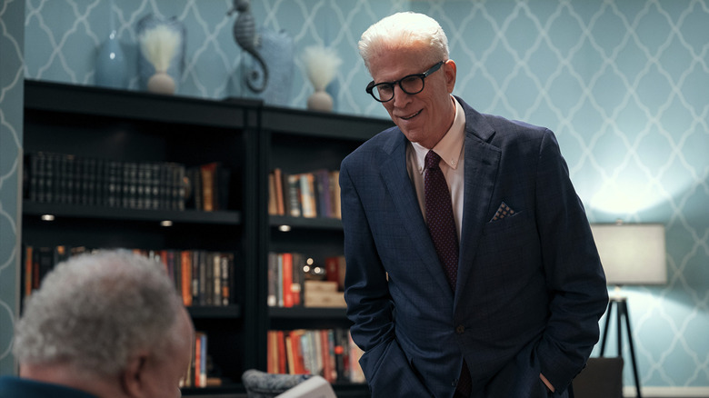 Ted Danson's Charles Nieuwendyk standing in an office talking to someone behind a desk on A Man on the Inside