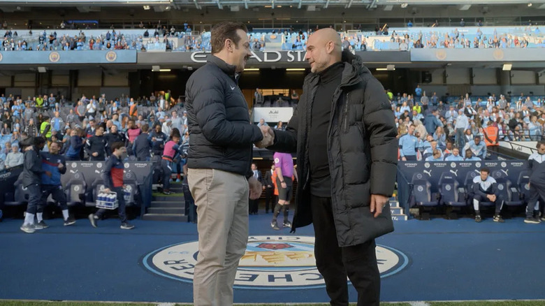 Ted Lasso and coach on the pitch