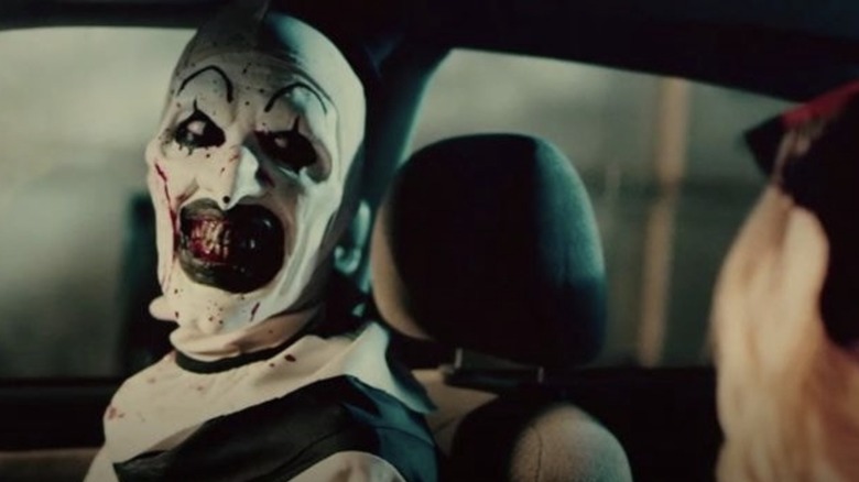 Art the Clown smiling in car