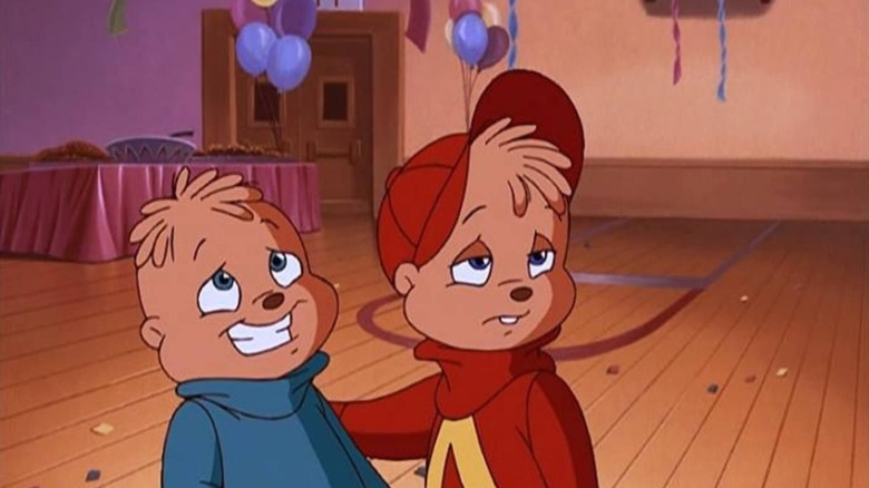 Theodore fakes a smile while Alvin gives a side eye in Alvin and the Chipmunks Meet the Wolfman