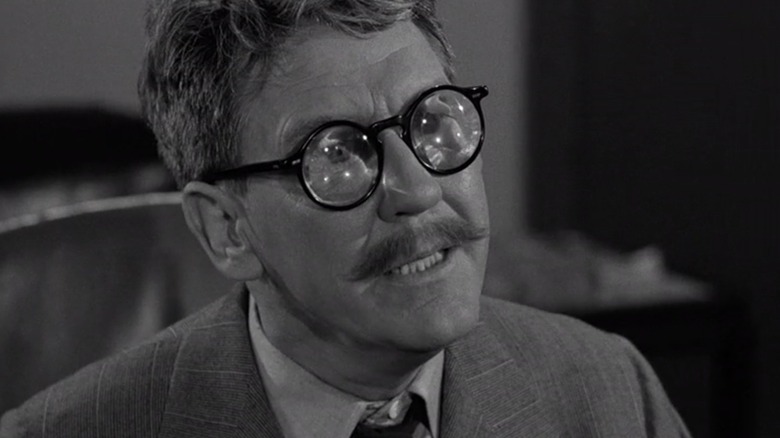 Burgess Meredith as Henry Bemis looking frustrated in his comical glasses