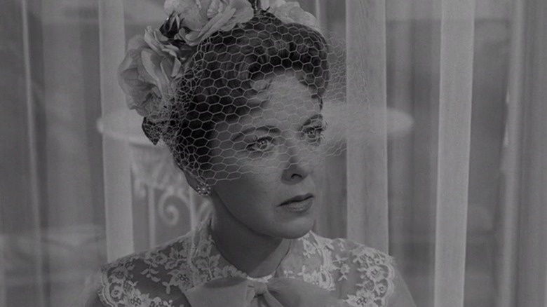 Ida Lupino as Barbara Jean, wearing a veil, looks upset in The Sixteen Millimeter Shrine