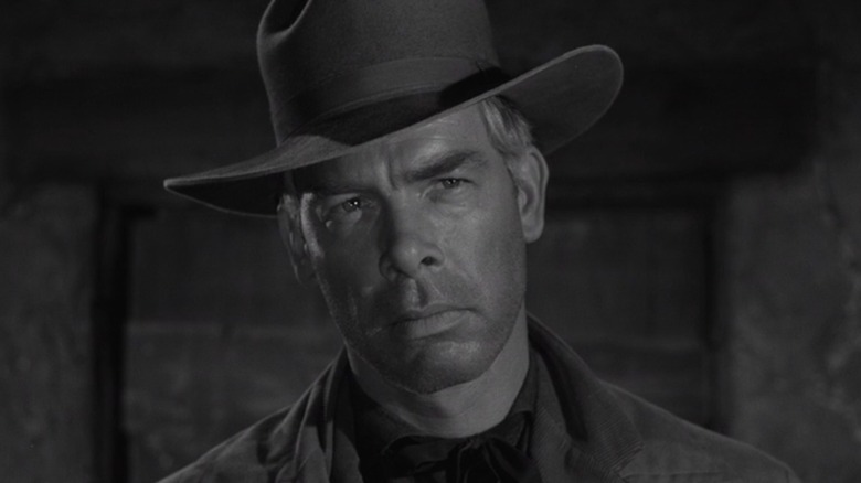 Lee Marvin as Conny Miller in a cowboy hat, staring at someone in The Grave