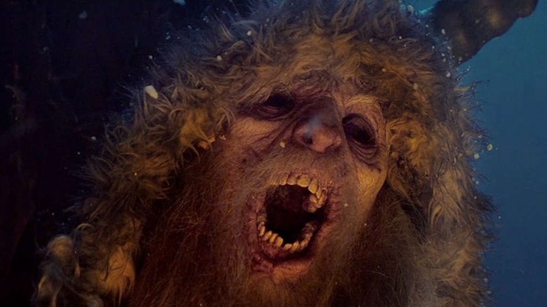 Krampus wearing his cloak with his mouth open in "Krampus" (2015)