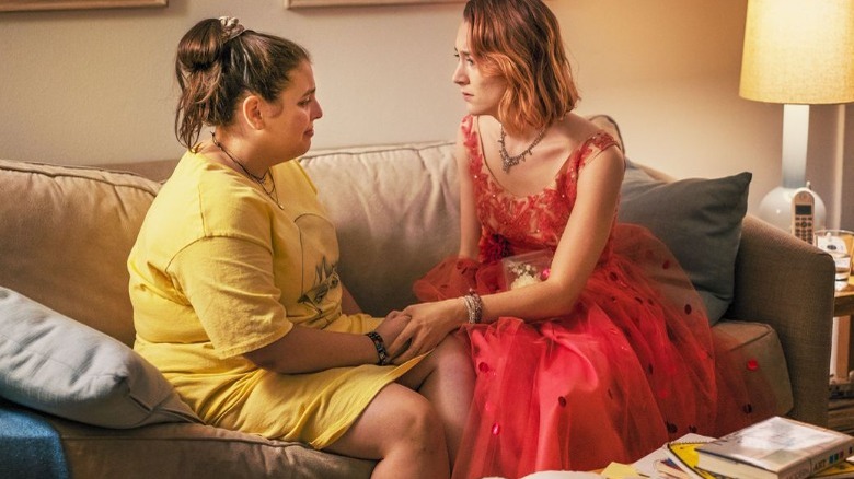saiorse ronan in lady bird sits on couch red dress