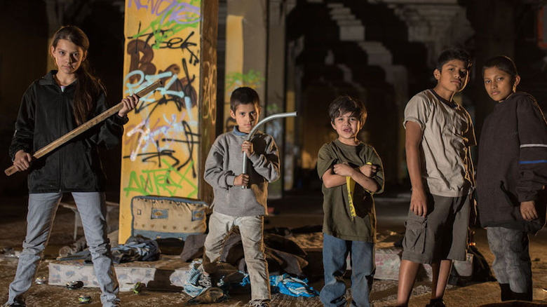 A group of kids wielding makeshift weapons in Tigers Are Not Afraid