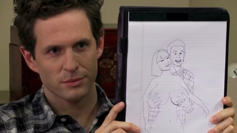 Glenn Howerton holding a drawing.