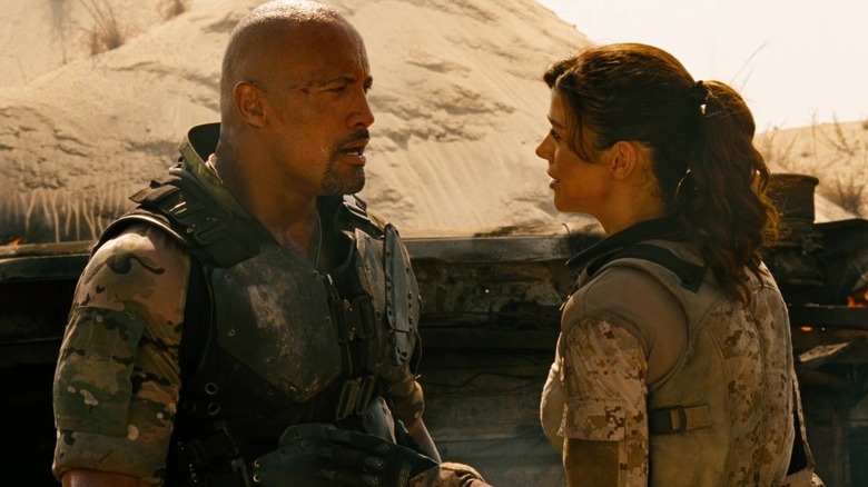 Dwayne Johnson as Roadblock and Adrianne Palicki as Lady Jaye prepare for a G.I. Joe Retaliation