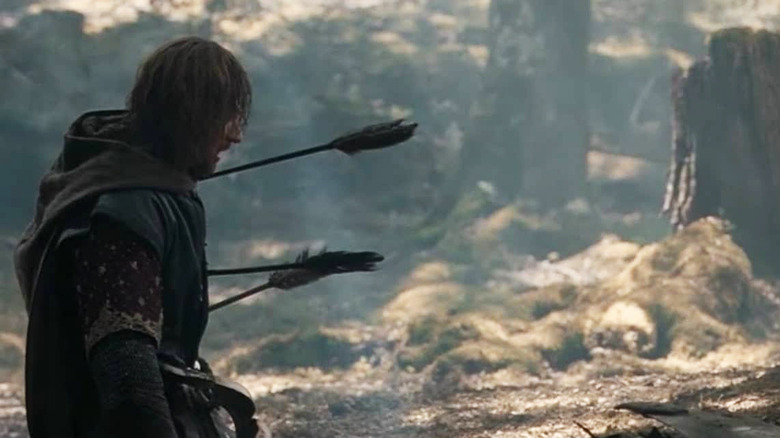 Sean Bean kneeling outside arrows the fellowship of the ring