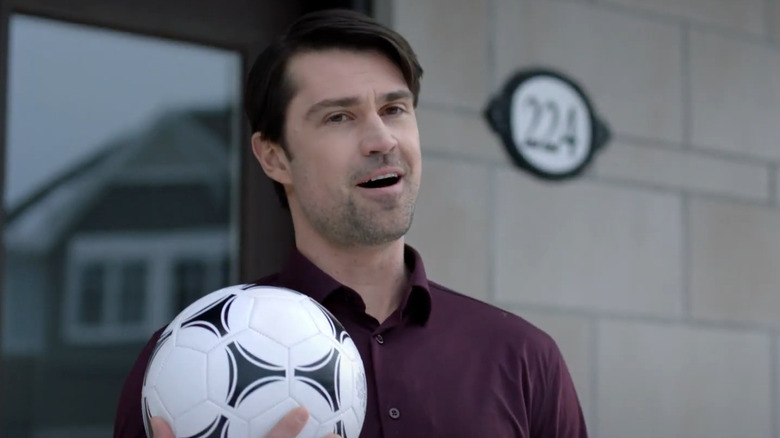 Jeremy holding a soccer ball in Noel Next Door.