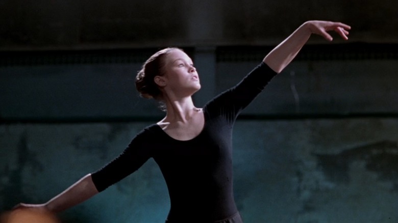 Sara from Save The Last Dance in a black leotard, dancing ballet with her arm held high