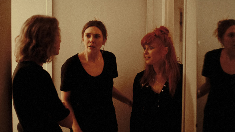 Katie, Rachel, and Christina talking in a hallway in His Three Daughters