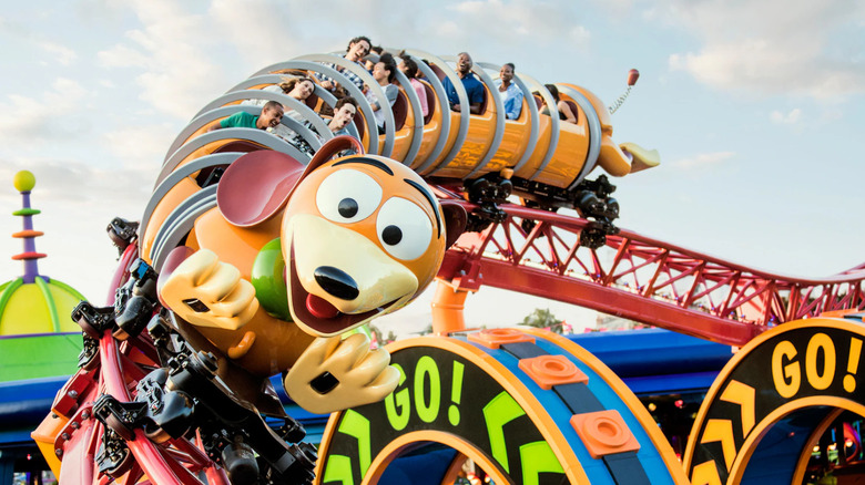 Guests raise their hands on Slinky Dog Dash