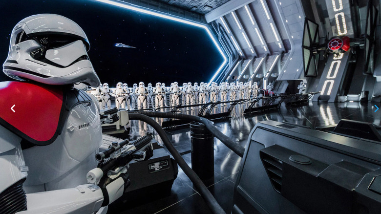 A Stormtrooper standing in front of a legion of troops in a docking bay