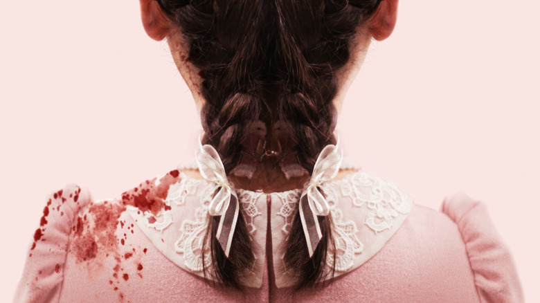 Esther's braided hair and in blood-stained dress