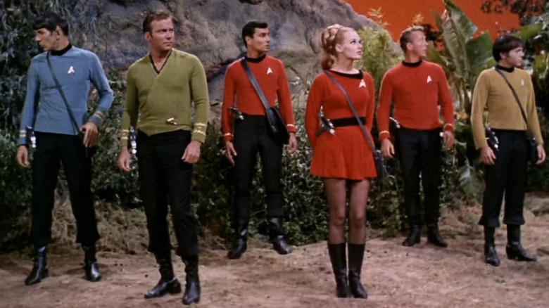 Spock, Kirk, Chekov, and some redshirts looking around an alien planet on Star Trek