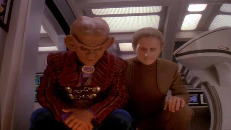 Armin Shimerman as Quark and Rene Auberjonois as Odo sitting together on Deep Space Nine