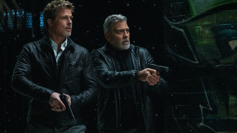 Brad Pitt and George Clooney as unnamed "fixers" with guns drawn in Wolfs