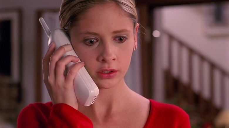 Buffy's Buffy Summers holding phone up to ear with tears in her eyes
