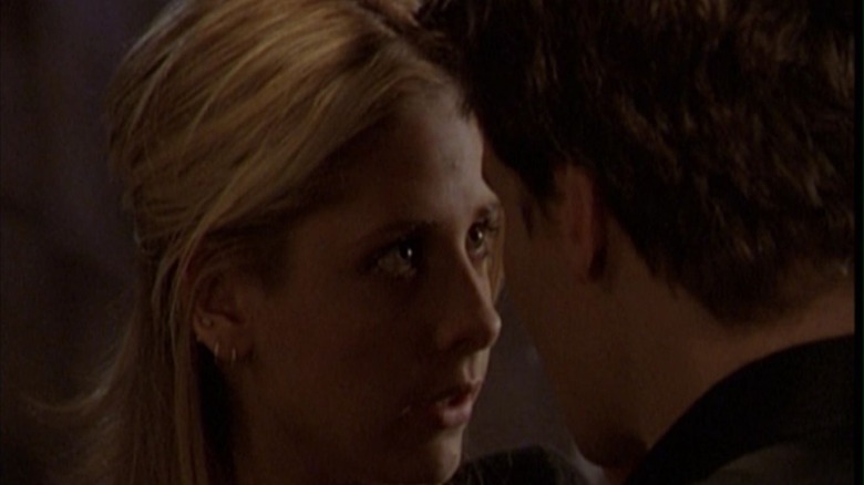 Buffy's Buffy Summers with head close to Angel's