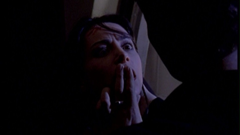 Buffy's Angel putting his fingers on Jenny's mouth