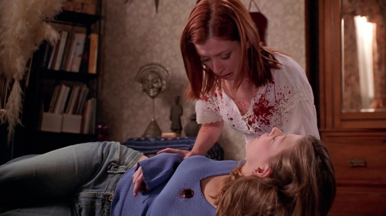 Buffy's Tara laying in Willow's arms with blood on shirt