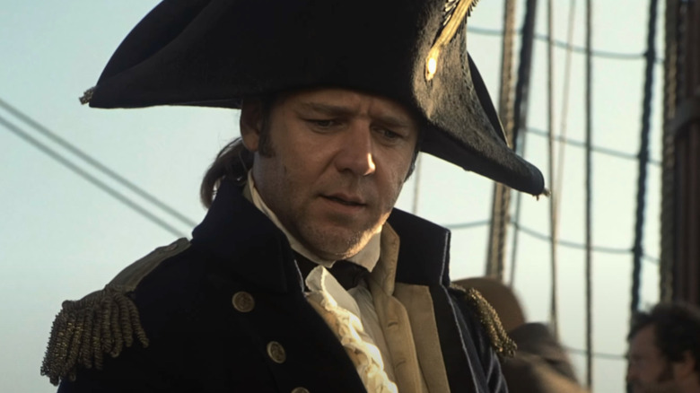 Russell Crowe as Jack Aubrey stands on a boat in Master and Commander: The Far Side of the World