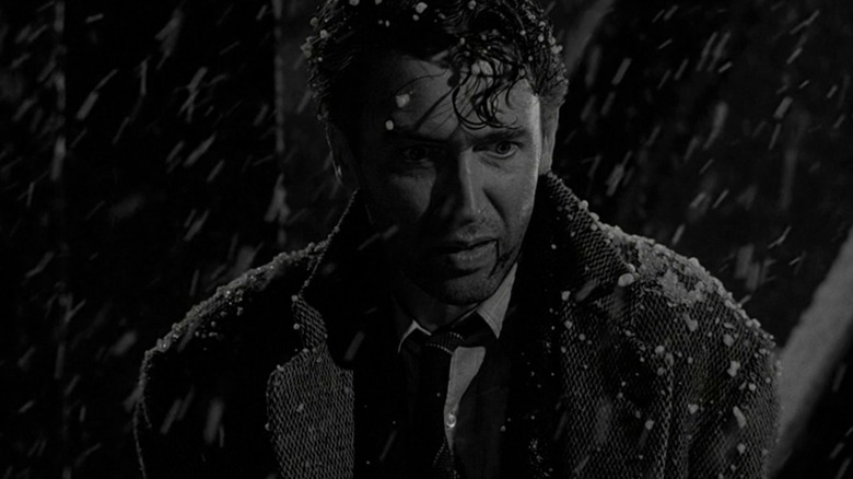 James Stewart's George looks down in horror in the snow in It's A Wonderful Life