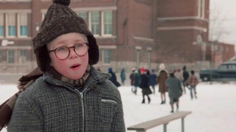 Peter Billingsley's Ralphie looks cold and concerned outside school in A Christmas Story