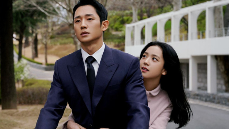 Eun Yeong-ro (Jisoo) clings to Lim Soo-ho (Jung Hae-in) as he rides a bicycle in Snowdrop