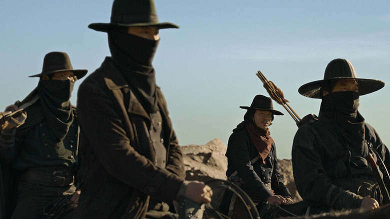 A gang of masked bandits ride on horseback in Song of the Bandits