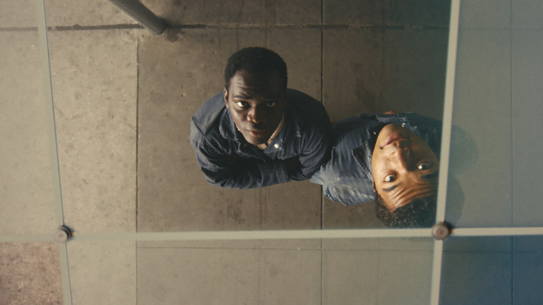 Ethan Herisse as Elwood and Brandon Wilson as Turner looking up at their reflections on the ceiling in Nickel Boys