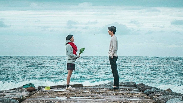 Kim Shin (Gong Yoo) looks at Ji Eun-tak (Kim Go-eun) by the ocean in Guardian: The Lonely and Great God