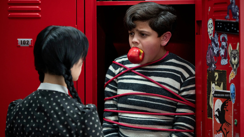 Wednesday looks at Pugsley tied up locker